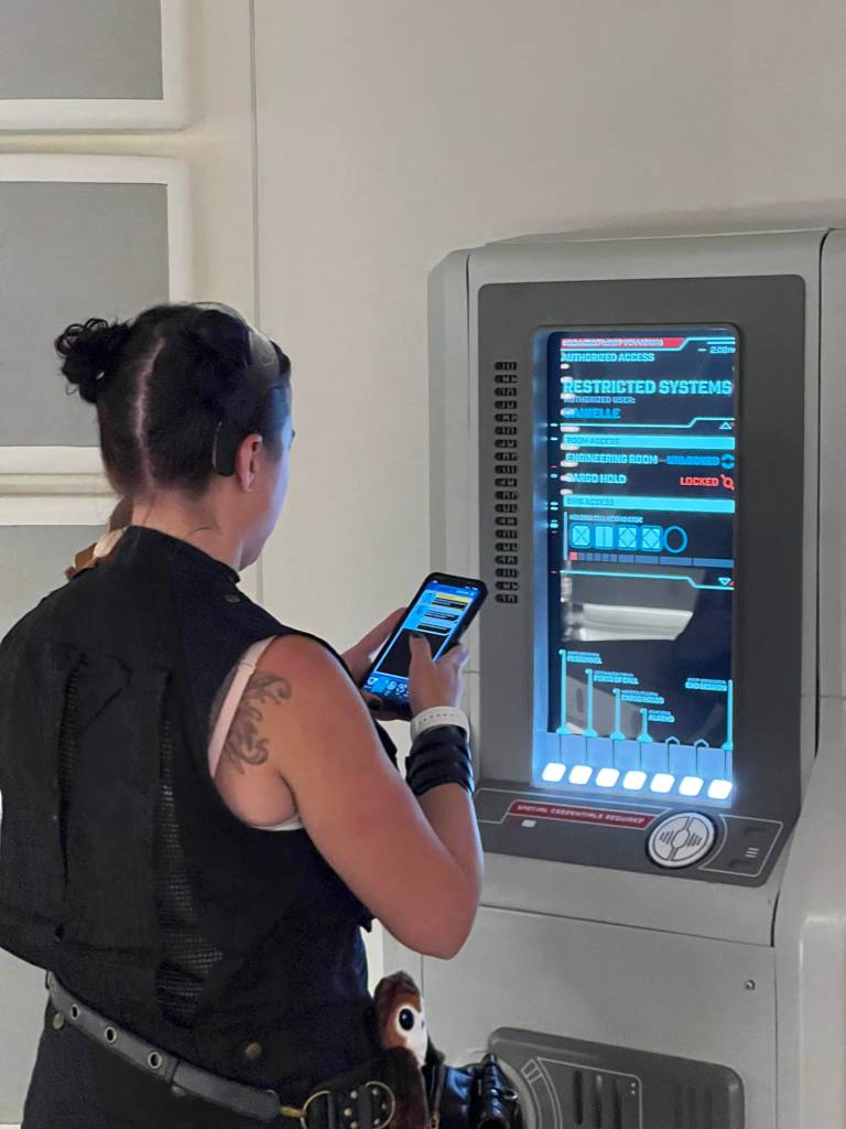 A guest using a console and phone