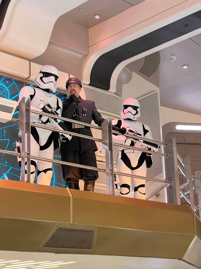 Croy and two stormtroopers on the atrium walkway