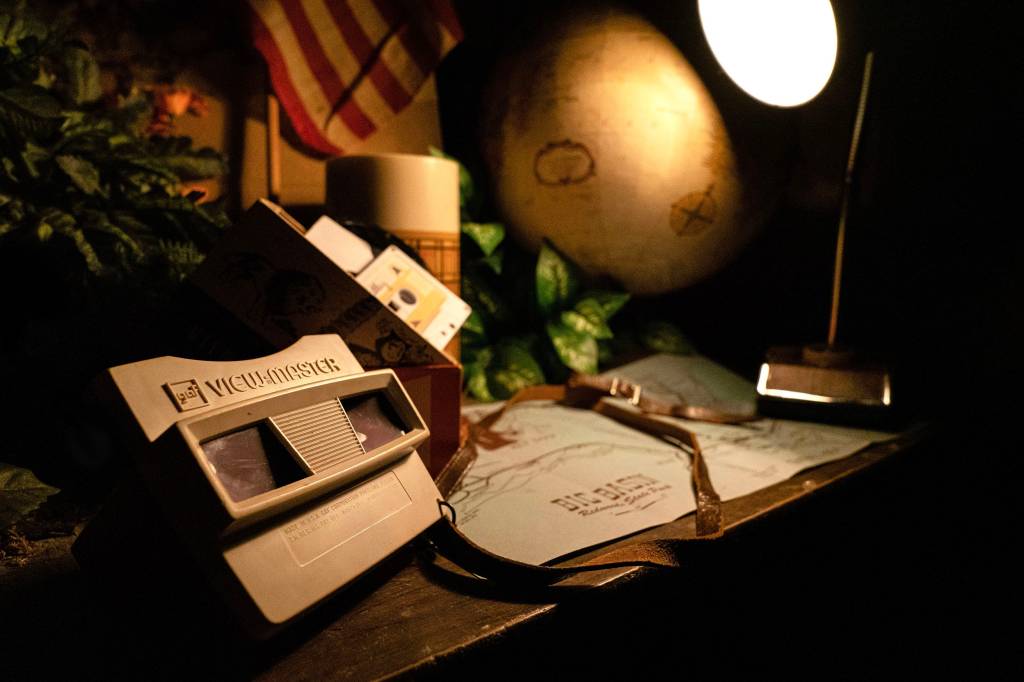 A table with a viewmaster, lamp, tape
