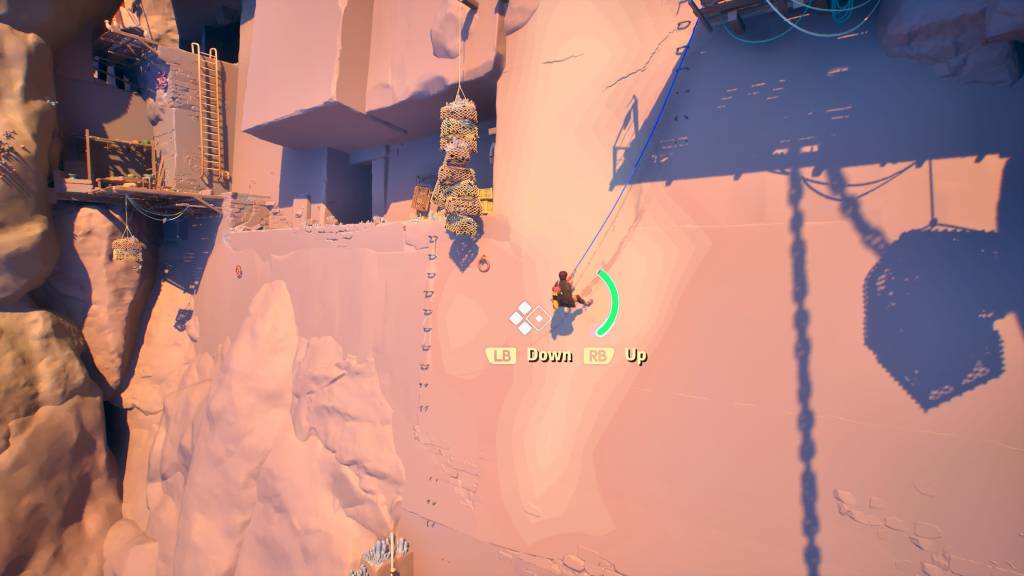 A personal rappelling down and swinging sideways across a cliff