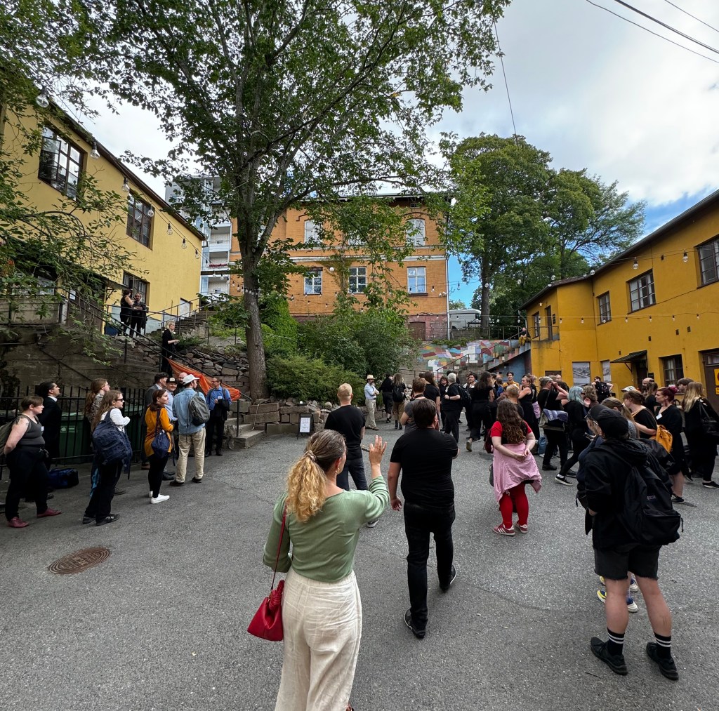 People gather in an outdoor courtyard