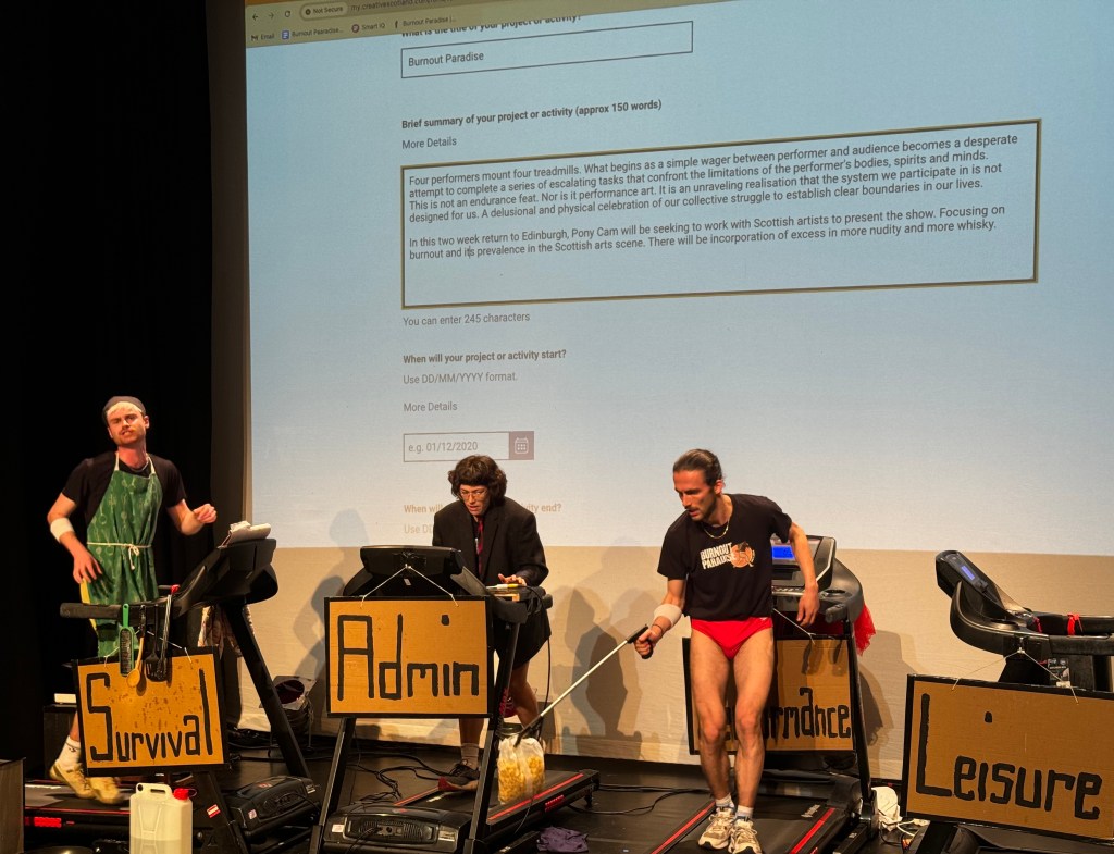 People on treadmills; the projection shows a half-completed application form.