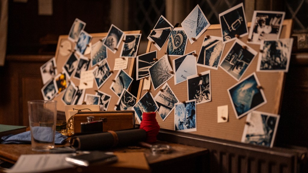 Two boards covered with polaroid photographs and notes