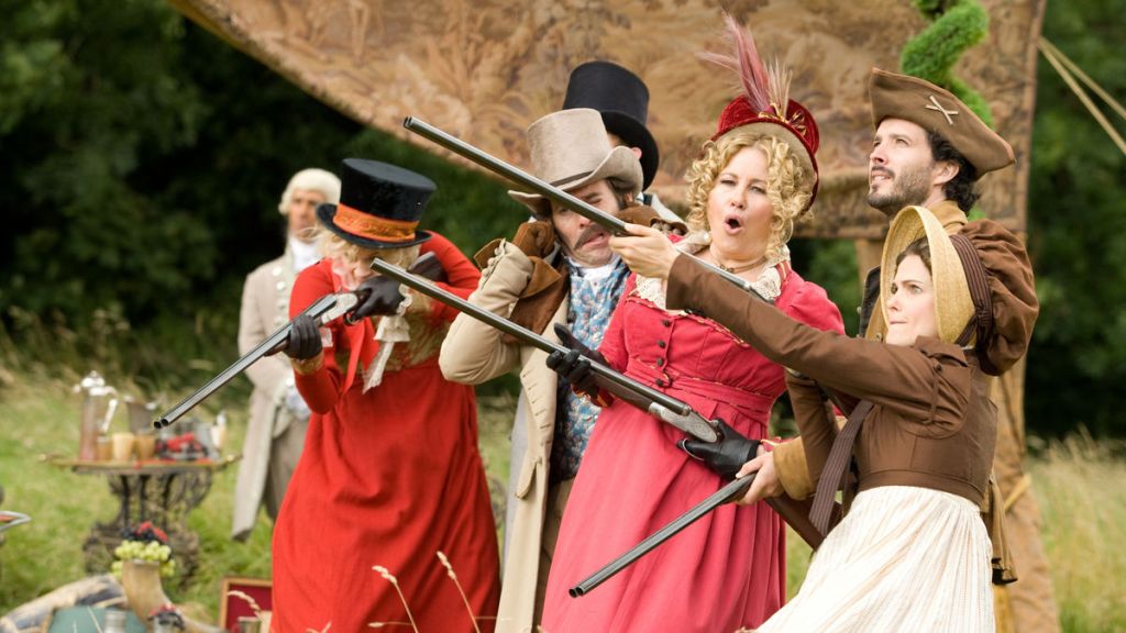 Women in period costume pointing rifles at the sky while men look on