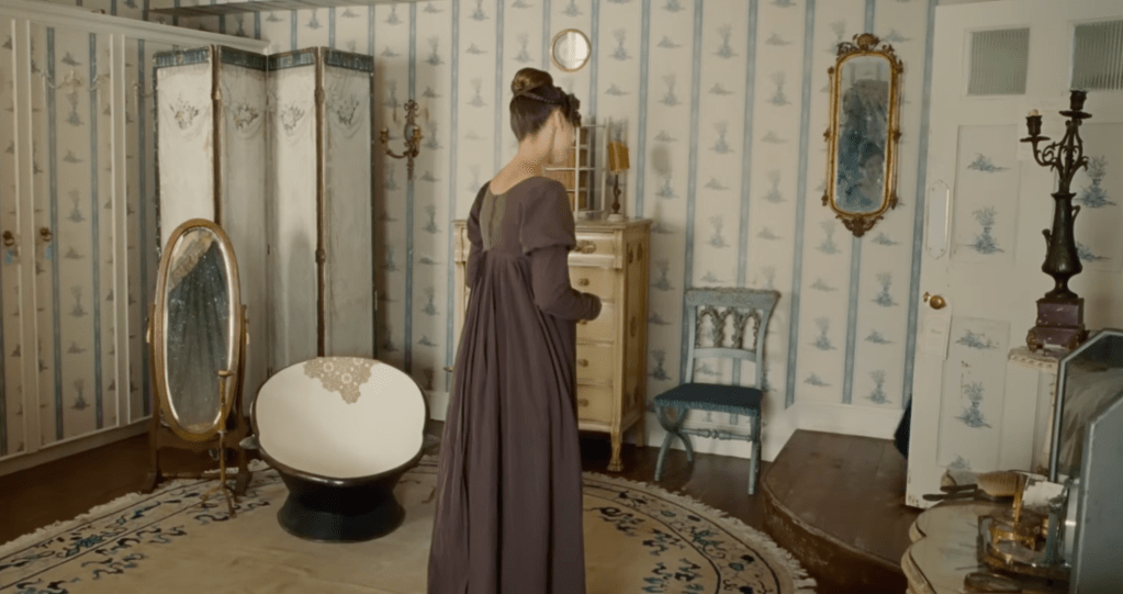 A woman in a smallish bedroom