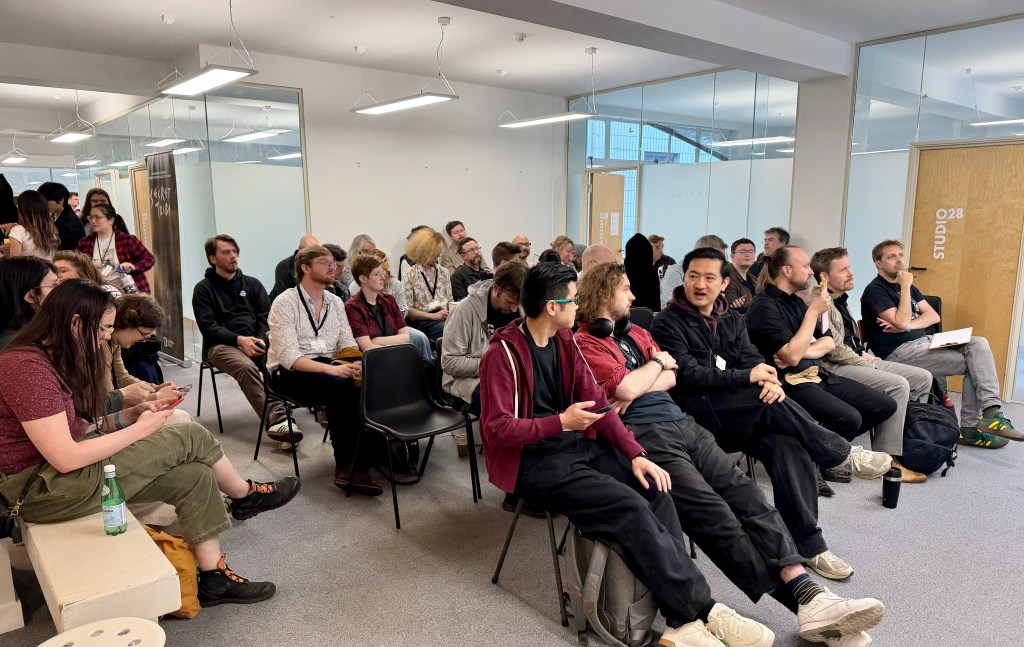 People sitting in the audience for talks to begin