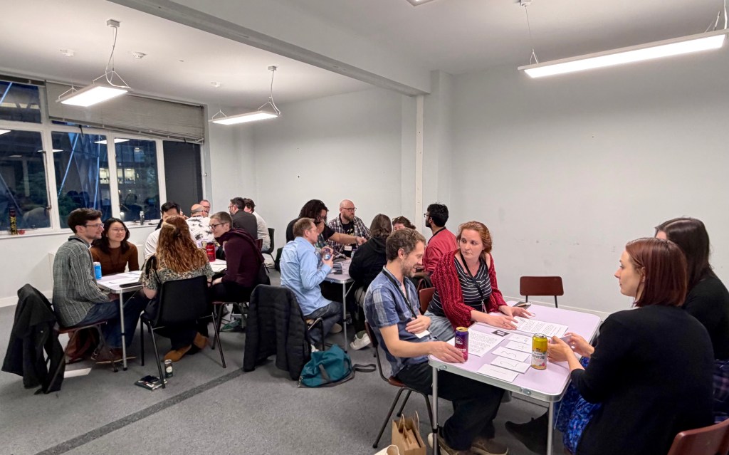 Four tables with 4-6 people playing around each