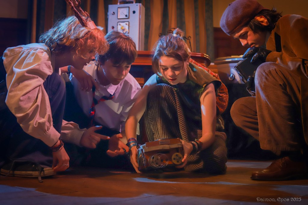 A group of students kneeling on the floor inspecting a box