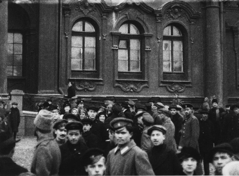 A crowd of people in front of a big building