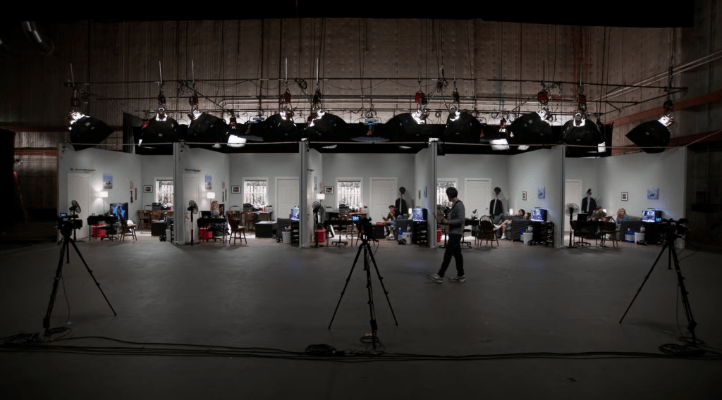 Five identical living room sets in a row in a big warehouse