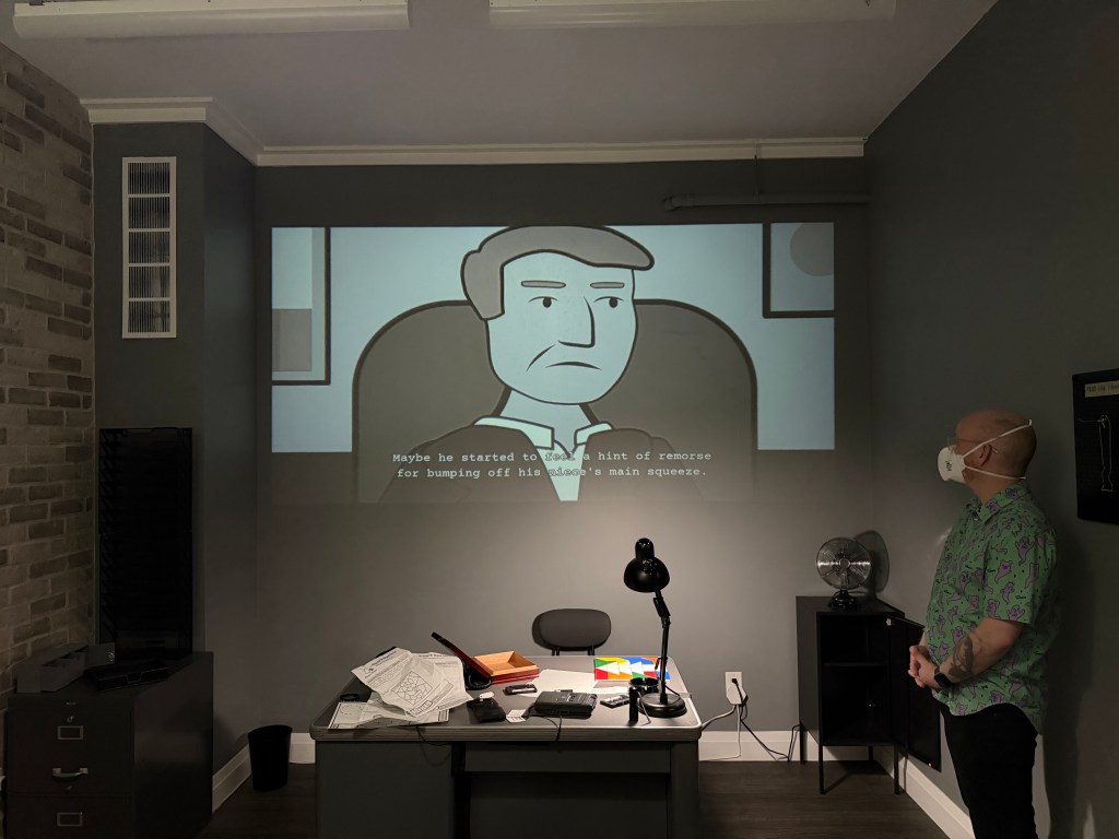 A black and white-coloured escape room that looks like an office. On the wall is a projected image with a carton of a man. The caption on the image reads: "Maybe he started to feel a hint of remorse for bumping off his niece's main squeeze."