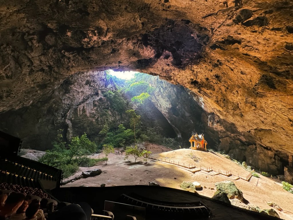 A massive dome-like screen showing the interior of a cave